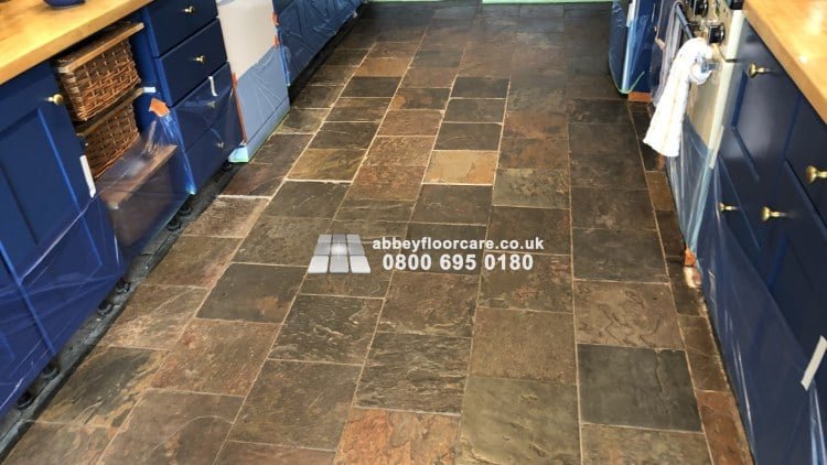 Patchy slate floor in Barnes with dull sealer residue before cleaning